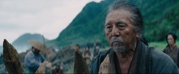 Movie still from “Silence” (2016), directed by Martin Scorsese – An old man with a beard and a mustache; Close Up shot, Over the shoulder angle