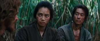 Movie still from “Silence” (2016), directed by Martin Scorsese – A young woman in a samurai garb in the woods; Close Up shot, Over the shoulder angle