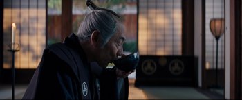 Movie still from “Silence” (2016), directed by Martin Scorsese – An older man drinking a glass of red wine; Close Up shot, Over the shoulder angle