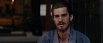 Movie still from “Silence” (2016), directed by Martin Scorsese – A person with long hair and a beard; Close Up shot, Over the shoulder angle