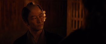 Movie still from “Silence” (2016), directed by Martin Scorsese – A man in a kimono looking to his left; Close Up shot, Over the shoulder angle