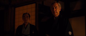 Movie still from “Silence” (2016), directed by Martin Scorsese – Two men in traditional garb in front of a building; Close Up shot, Low angle