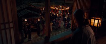 Movie still from “Silence” (2016), directed by Martin Scorsese – A group of people sitting in front of a building; Extreme Wide shot, High angle
