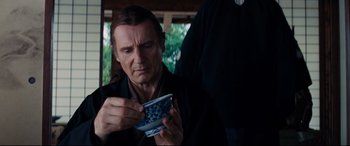 Movie still from “Silence” (2016), directed by Martin Scorsese – A man holding a blue and white cup in his hands; Close Up shot, Over the shoulder angle