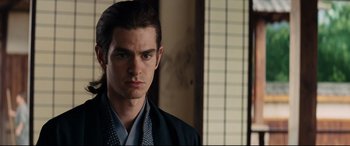 Movie still from “Silence” (2016), directed by Martin Scorsese – A person wearing a robe; Close Up shot, Over the shoulder angle