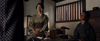 Movie still from “Silence” (2016), directed by Martin Scorsese – A woman in a kimono sitting in a room; Medium shot, Low angle