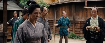 Movie still from “Silence” (2016), directed by Martin Scorsese – A group of people standing next to each other on a street; Medium shot, Low angle