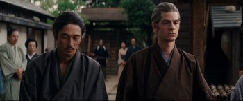Movie still from “Silence” (2016), directed by Martin Scorsese – Two men in traditional garb walking down a street; Close Up shot, Low angle