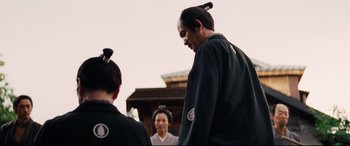Movie still from “Silence” (2016), directed by Martin Scorsese – A man and two women in traditional japanese clothing; Medium shot, Over the shoulder angle