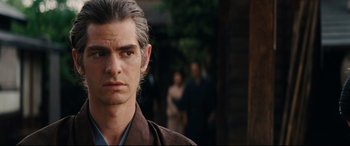 Movie still from “Silence” (2016), directed by Martin Scorsese – A man that is looking at the camera; Close Up shot, Over the shoulder angle