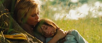 Movie still from “Silent Hill” (2006), directed by Christophe Gans – A woman and a child laying in the grass; Close Up shot, High angle