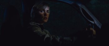 Movie still from “Silent Hill” (2006), directed by Christophe Gans – A woman sitting in the driver's seat of a car at night; Close Up shot, Over the shoulder angle