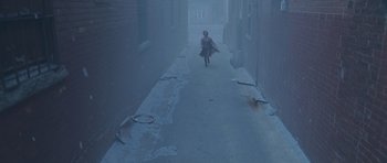 Movie still from “Silent Hill” (2006), directed by Christophe Gans – A woman walking down a street in the middle of the day; Extreme Wide shot, High angle