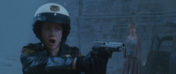 Movie still from “Silent Hill” (2006), directed by Christophe Gans – A police officer is holding a gun up to a woman's face; Close Up shot, Low angle