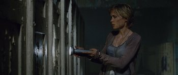 Movie still from “Silent Hill” (2006), directed by Christophe Gans – A woman holding a cell phone in her hands; Medium shot, Low angle