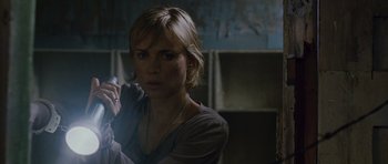 Movie still from “Silent Hill” (2006), directed by Christophe Gans – A young woman holding a cell phone in her hand; Close Up shot, Over the shoulder angle