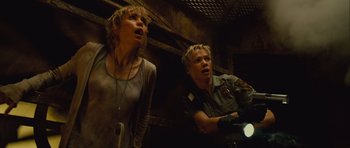 Movie still from “Silent Hill” (2006), directed by Christophe Gans – A woman and a police officer looking at something in the dark; Medium shot, Low angle