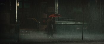 Movie still from “Silent Hill” (2006), directed by Christophe Gans – A man holding an umbrella while standing in the rain; Extreme Wide shot, Low angle
