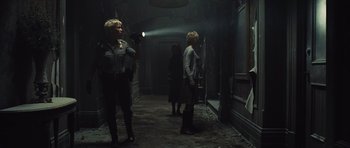 Movie still from “Silent Hill” (2006), directed by Christophe Gans – A group of people standing in a dark hallway; Wide shot, Low angle