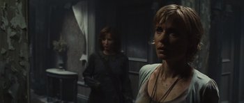 Movie still from “Silent Hill” (2006), directed by Christophe Gans – Two women standing next to each other in a dark room; Close Up shot, Over the shoulder angle