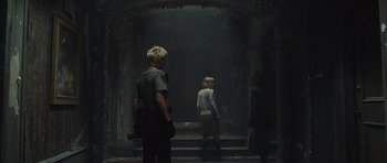 Movie still from “Silent Hill” (2006), directed by Christophe Gans – A group of people standing in a dark room; Wide shot, Low angle