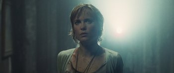 Movie still from “Silent Hill” (2006), directed by Christophe Gans – A woman with short blonde hair wearing a white shirt; Close Up shot, Low angle