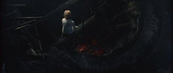 Movie still from “Silent Hill” (2006), directed by Christophe Gans – A man standing in front of a fire pit; Wide shot, Overhead angle