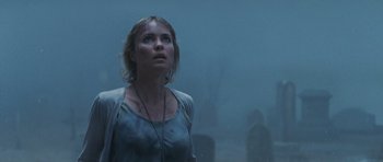 Movie still from “Silent Hill” (2006), directed by Christophe Gans – A woman standing in the fog looking up at the sky; Close Up shot, Low angle