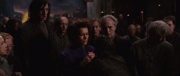 Movie still from “Silent Hill” (2006), directed by Christophe Gans – A group of people standing around each other in a room; Medium shot, Over the shoulder angle