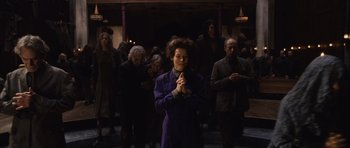 Movie still from “Silent Hill” (2006), directed by Christophe Gans – A group of people standing around a building; Medium shot, High angle