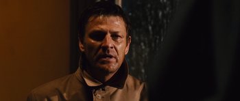 Movie still from “Silent Hill” (2006), directed by Christophe Gans – A person wearing a brown jacket; Close Up shot, Over the shoulder angle