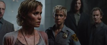 Movie still from “Silent Hill” (2006), directed by Christophe Gans – A woman standing next to a man in a police uniform; Close Up shot, Over the shoulder angle
