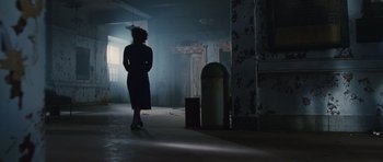 Movie still from “Silent Hill” (2006), directed by Christophe Gans – A woman standing in a dark room in a dark place; Wide shot, Low angle