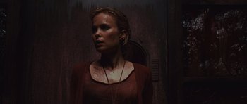 Movie still from “Silent Hill” (2006), directed by Christophe Gans – A woman in a red shirt is standing in front of a wall; Close Up shot, Low angle