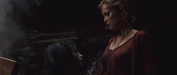 Movie still from “Silent Hill” (2006), directed by Christophe Gans – A woman standing next to another woman in a dark room; Medium shot, Low angle