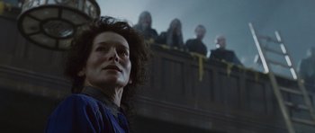 Movie still from “Silent Hill” (2006), directed by Christophe Gans – A woman standing in front of a group of people; Close Up shot, Low angle