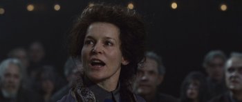 Movie still from “Silent Hill” (2006), directed by Christophe Gans – An older woman with curly brown hair is looking at the camera; Close Up shot, Low angle