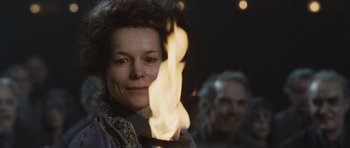 Movie still from “Silent Hill” (2006), directed by Christophe Gans – A woman is holding a candle in front of a crowd; Close Up shot, Low angle