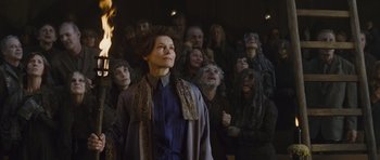 Movie still from “Silent Hill” (2006), directed by Christophe Gans – A woman standing in front of a group of people; Medium shot, Low angle