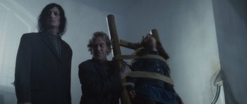 Movie still from “Silent Hill” (2006), directed by Christophe Gans – A man and a woman tied to a wooden ladder; Medium shot, Low angle