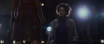 Movie still from “Silent Hill” (2006), directed by Christophe Gans – A woman standing next to another woman in a dark room; Medium shot, Low angle