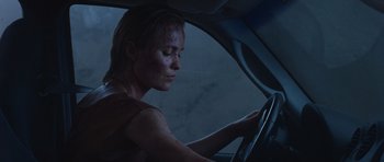 Movie still from “Silent Hill” (2006), directed by Christophe Gans – A woman sitting in the driver's seat of a car at night; Close Up shot, Over the shoulder angle