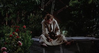 Movie still from “Silent Running” (1972), directed by Douglas Trumbull – A man sitting on a bench in the dark; Wide shot, High angle