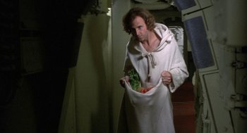 Movie still from “Silent Running” (1972), directed by Douglas Trumbull – A man in a robe holding a bag of vegetables; Medium shot, High angle