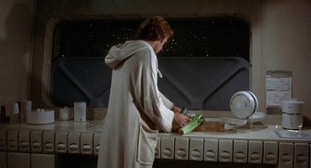 Movie still from “Silent Running” (1972), directed by Douglas Trumbull – A man in a white robe standing in front of a counter; Medium shot, Low angle