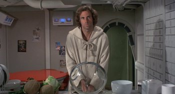 Movie still from “Silent Running” (1972), directed by Douglas Trumbull – A man standing in front of a table with a bowl on top of it; Medium shot, Low angle