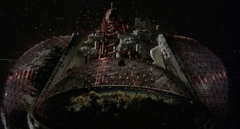Movie still from “Silent Running” (1972), directed by Douglas Trumbull – An overhead view of a building at night with lights on it; Extreme Wide shot, Overhead angle