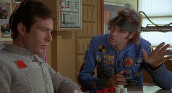 Movie still from “Silent Running” (1972), directed by Douglas Trumbull – Two men sitting at a table playing a board game; Medium shot, Over the shoulder angle