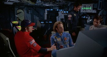 Movie still from “Silent Running” (1972), directed by Douglas Trumbull – A group of people sitting around a computer in a room; Medium shot, High angle