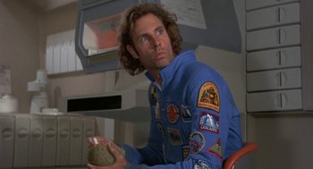 Movie still from “Silent Running” (1972), directed by Douglas Trumbull – A man in a space suit holding a rock; Close Up shot, Low angle